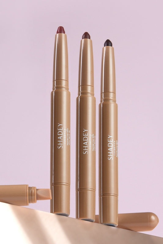 Three SHADEY lip liner pencils on a light purple background